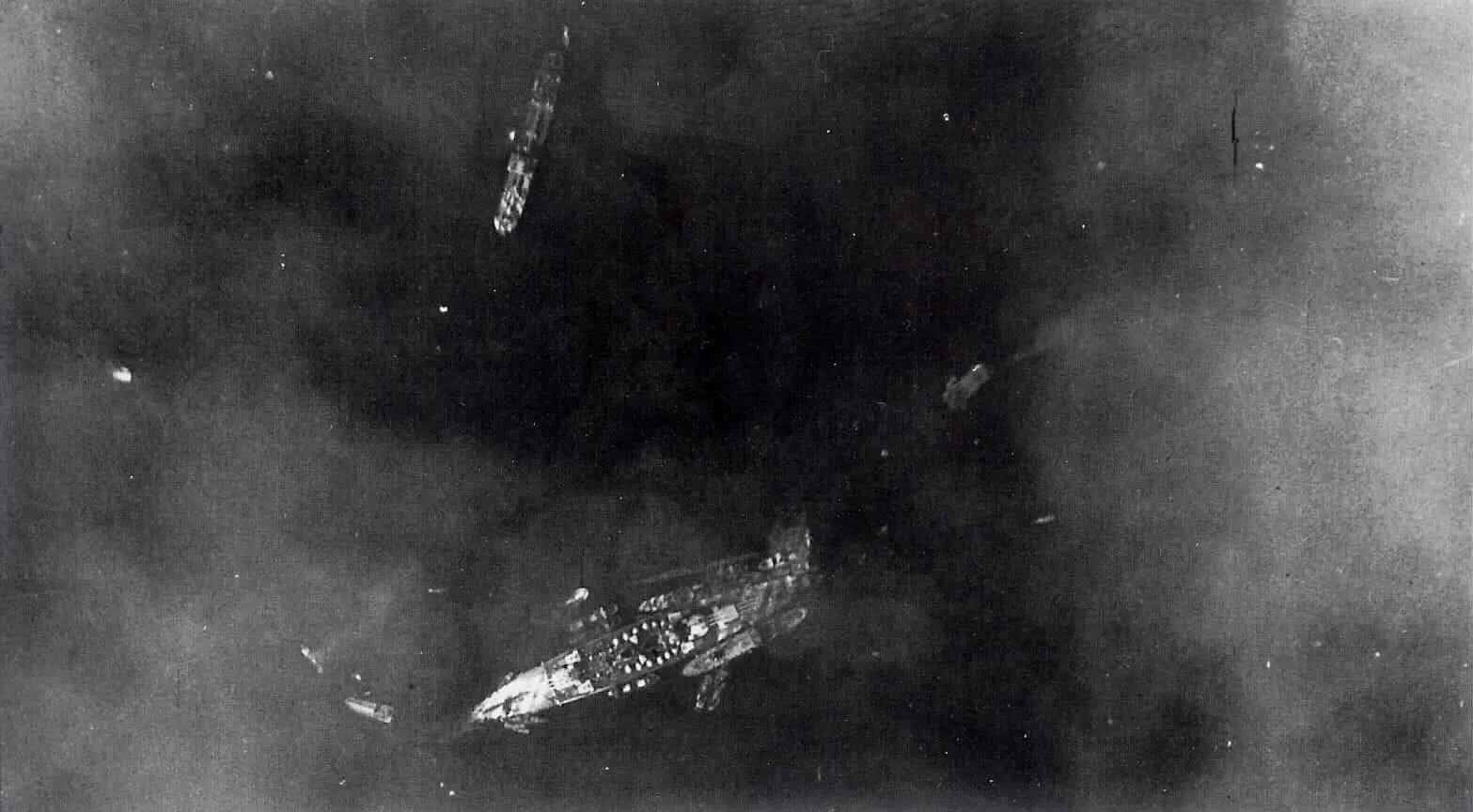 Aerial view of the Italian battleship Littorio in Taranto harbour after the British attack of 12 November 1940.