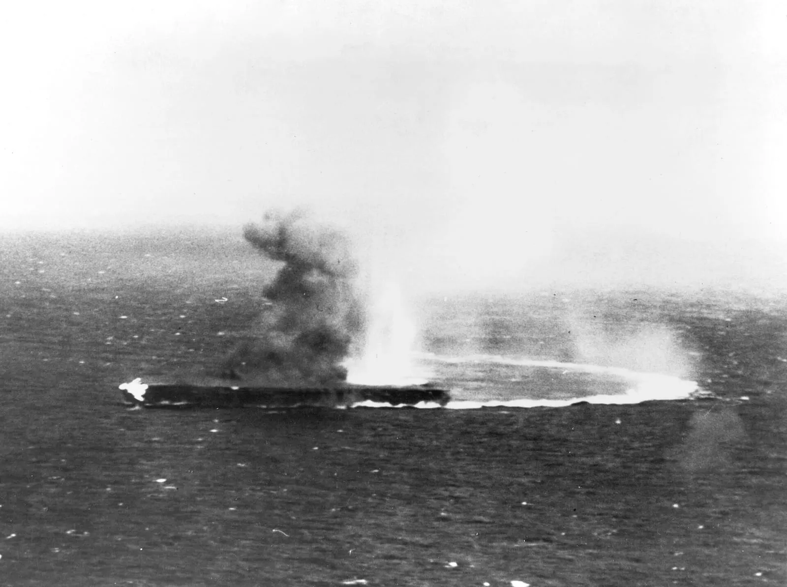 The Japanese carrier Shōkaku under attack by aircraft from USS Yorktown on the morning of 8 May 1942.
