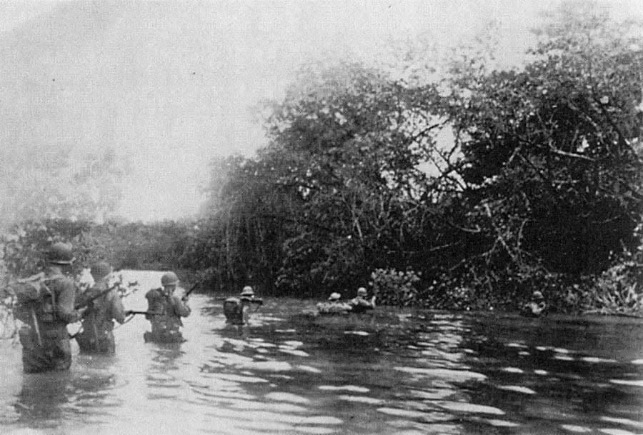 American soldiers crossing the Driniumor River in July 1944.