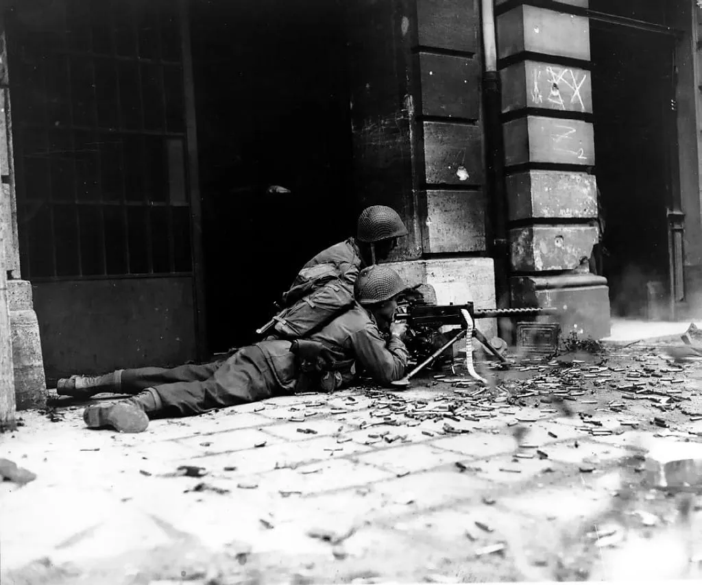 A US machine-gun crew of the 2nd Battalion, 26th Infantry, in the streets of Aachen, 15 October 1944.