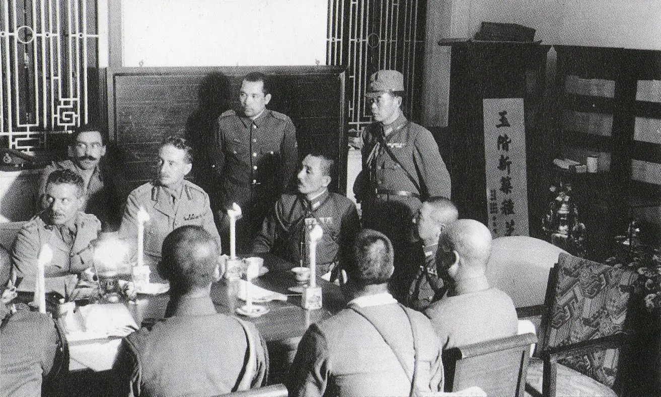 Major General Maltby discussing the arrangements for surrender with the Japanese at the Peninsula Hotel, 25 December 1941.