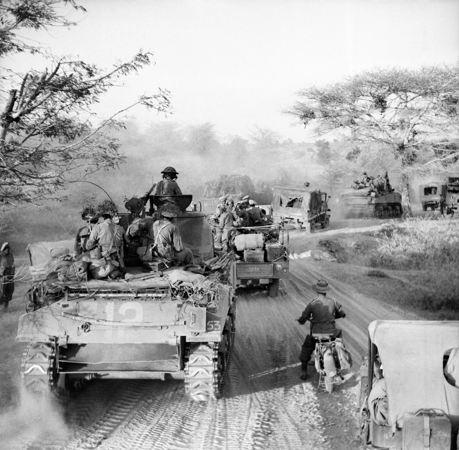 Sherman tanks and trucks of the 62nd Motorised Brigade on the road from the Irrawaddy bridgehead to Meiktila, March 1945.