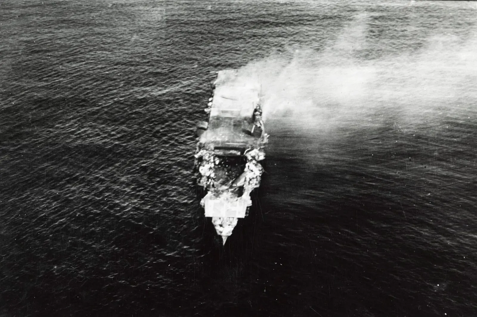 The burning Japanese aircraft carrier Hiryū at sunrise on 5 June 1942; she sank a few hours later.