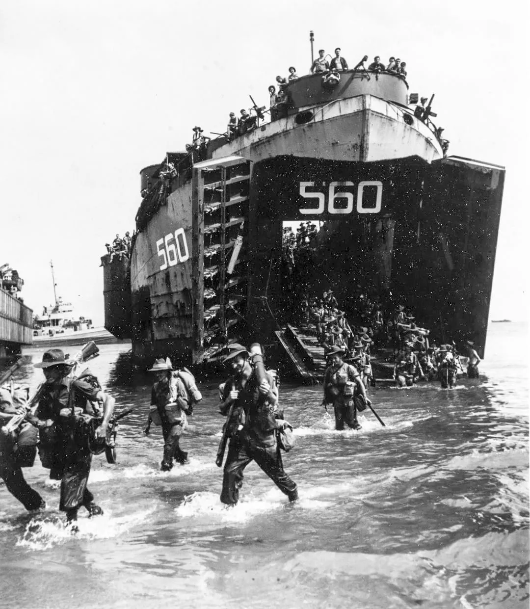 Australian troops land from USS LST-560 on Labuan Island in Brunei Bay, 10 June 1945.