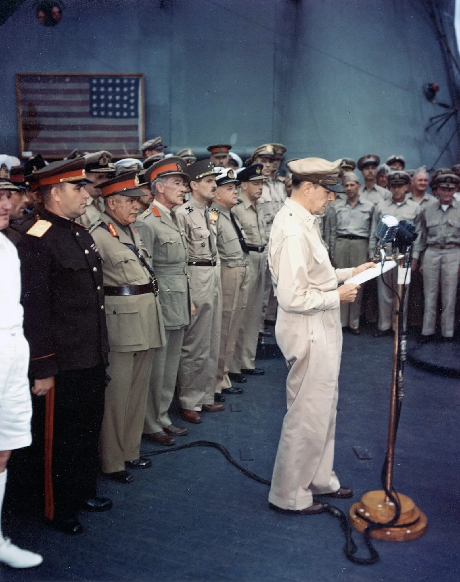 General Douglas MacArthur reads his speech opening the Japanese surrender ceremony in Tokyo Bay, 2 September 1945.