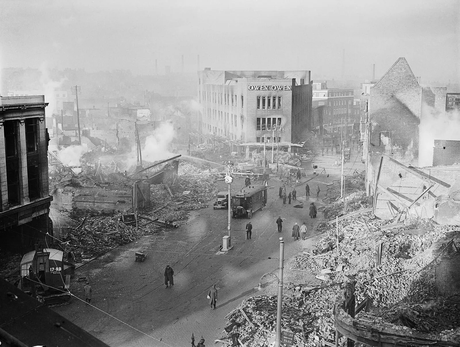 Broadgate in the centre of Coventry after the raid of 14/15 November 1940, with the burnt-out shell of the Owen Owen department store.