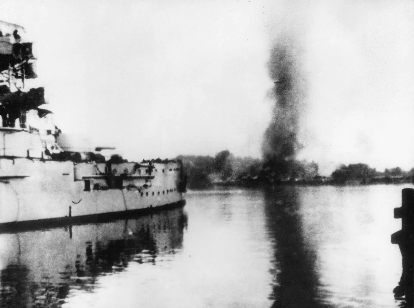 The German battleship Schleswig-Holstein firing at the Polish Military Transit Depot during the siege of Westerplatte.