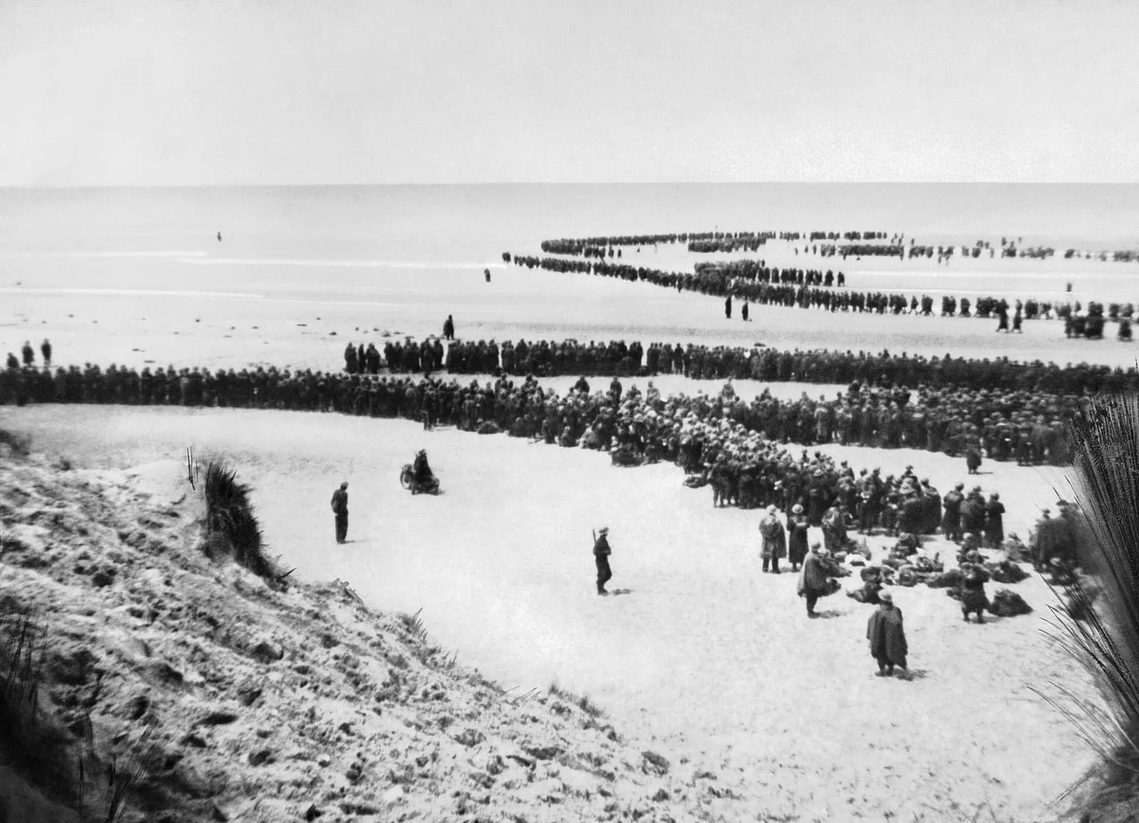 British troops line up on the beach at Dunkirk to await evacuation, May 1940.