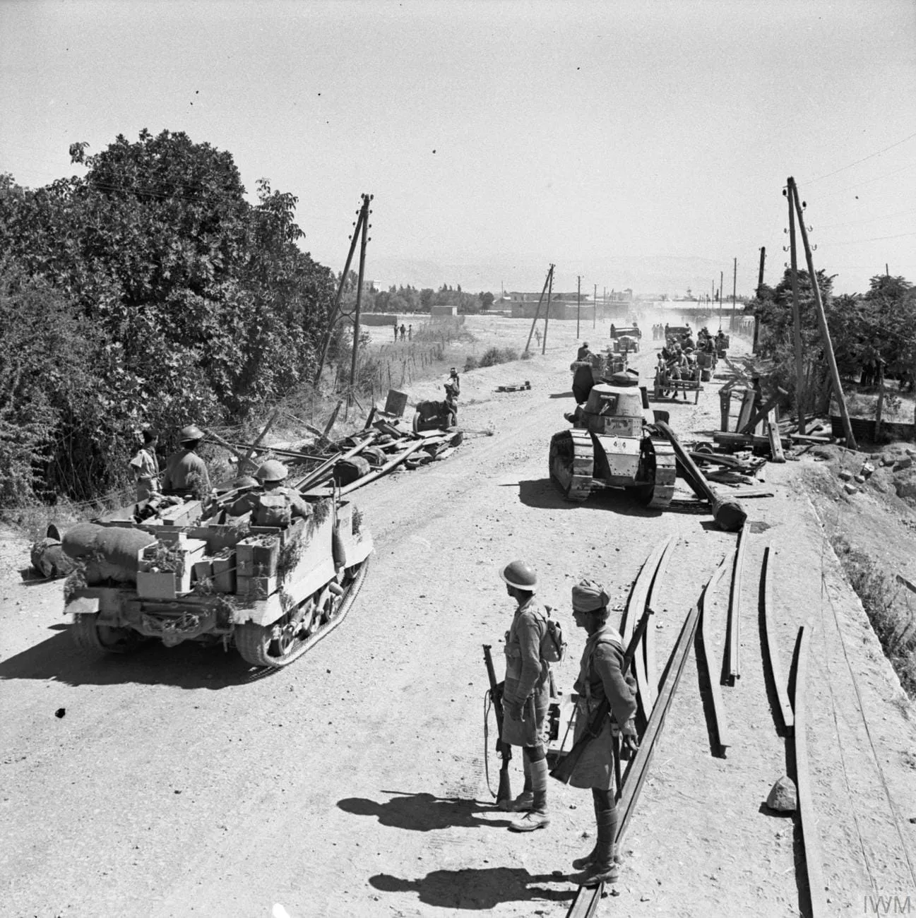 Indian troops in Bren gun carriers outside Damascus, 26 June 1941; a wrecked Vichy French tank is on the right.