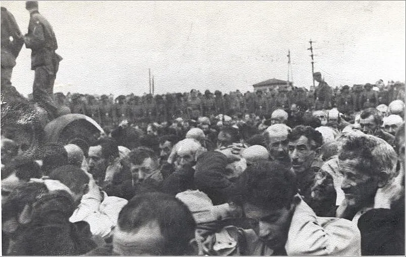 Liquidation of the Białystok Ghetto, 15–20 August 1943: Jewish men with their hands up, watched by a German military unit.