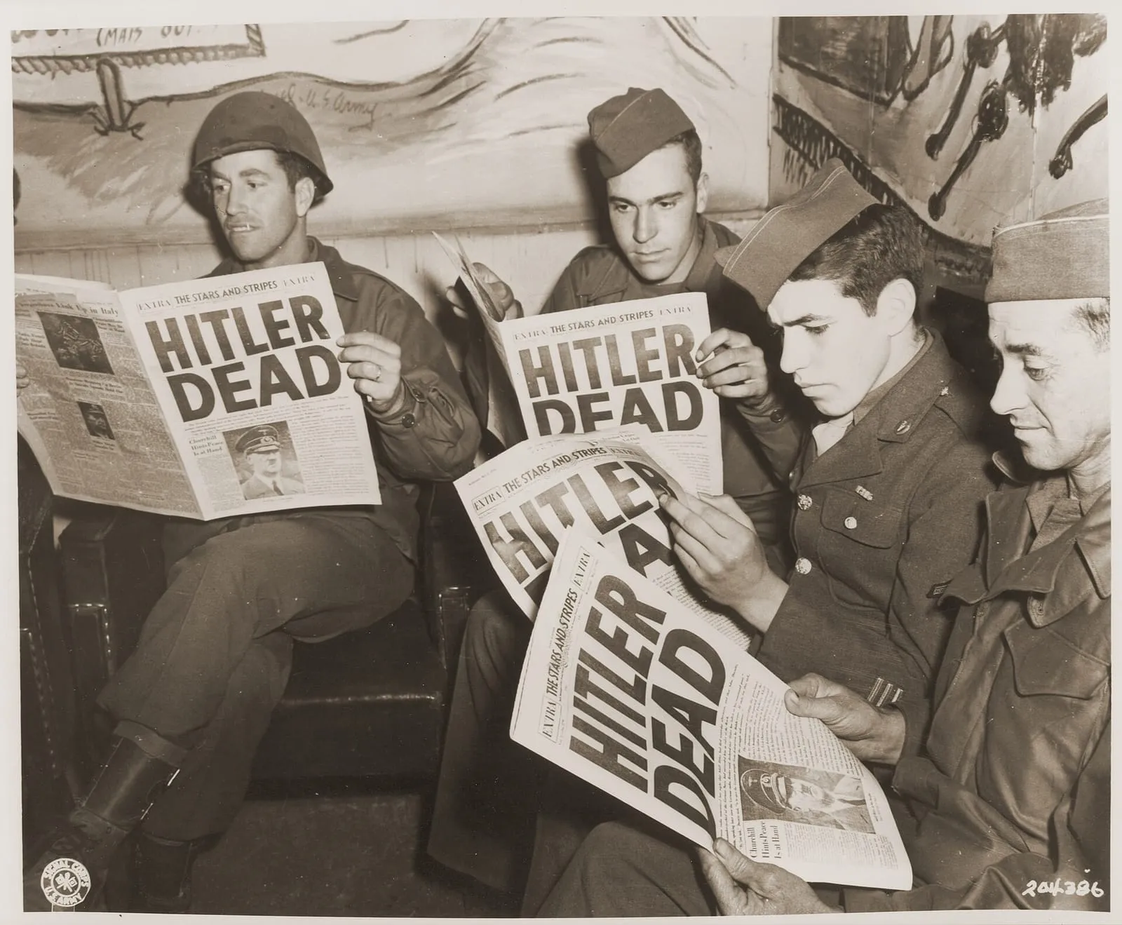 American soldiers read of Hitler’s death in an extra edition of “Stars and Stripes”, 2 May 1945.