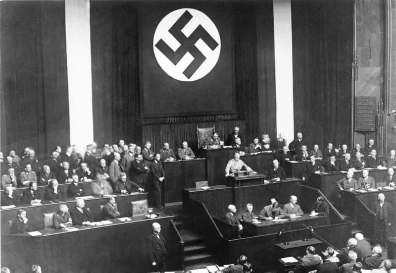 Adolf Hitler presenting the Enabling Act to the Reichstag, sitting in the Kroll Opera House in Berlin, 23 March 1933.