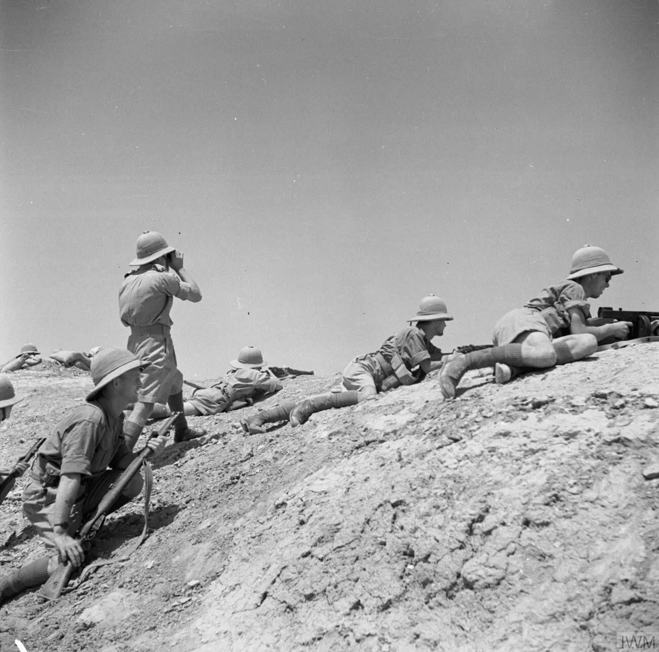 A firing party covers Royal Engineers building a temporary bridge near Ramadi, a stronghold of the Iraqi rebels, 1 June 1941.